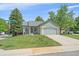 Attractive single-story home with a well-kept lawn and a two-car garage at 9406 Troon Village Way, Lone Tree, CO 80124