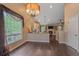 Bright open concept space with wood floors, living room fireplace and kitchen at 9406 Troon Village Way, Lone Tree, CO 80124