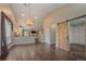 Spacious living room with cathedral ceiling, wood floors, fireplace and barn door accents at 9406 Troon Village Way, Lone Tree, CO 80124