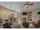 Open-concept living room with a fireplace, built-in shelves, and kitchen island seating at 9406 Troon Village Way, Lone Tree, CO 80124
