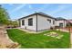 Landscaped backyard featuring a lush lawn, a stone fire pit, and a well-maintained fence, ideal for outdoor enjoyment at 21376 E Union Pl, Aurora, CO 80015