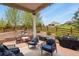 Charming outdoor patio area with ample seating, a grill, and a lush backyard, perfect for entertaining and relaxation at 21376 E Union Pl, Aurora, CO 80015