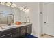 Bathroom featuring double sink vanity, granite counters, and ample lighting at 21376 E Union Pl, Aurora, CO 80015