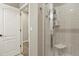 This bathroom features a tiled shower with a built-in seat and glass doors, creating a modern and accessible space at 21376 E Union Pl, Aurora, CO 80015