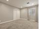 Neutral bedroom featuring a large window with curtains, plush carpet and closet with sliding doors at 21376 E Union Pl, Aurora, CO 80015