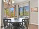 Bright dining room with dark wood table, chairs and view to the home's outdoor living space at 21376 E Union Pl, Aurora, CO 80015