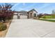 Spacious home with a three-car garage, a well-manicured lawn, and beautiful landscaping at 21376 E Union Pl, Aurora, CO 80015
