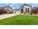 Attractive single-Gathering home featuring stone accents, a lush green lawn, and a three-car garage at 21376 E Union Pl, Aurora, CO 80015