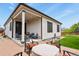 A welcoming back patio with string lights, seating and a fire pit for cozy evenings and a grassy backyard at 21376 E Union Pl, Aurora, CO 80015