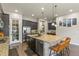 Modern kitchen featuring a large island, stainless steel appliances, and dark wood cabinets at 21376 E Union Pl, Aurora, CO 80015