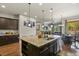 Open-concept kitchen showcasing a large island, granite countertops, and stainless steel appliances at 21376 E Union Pl, Aurora, CO 80015
