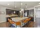 Spacious kitchen with a large center island, stainless steel appliances, and dark cabinetry at 21376 E Union Pl, Aurora, CO 80015
