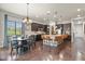 Open-concept kitchen and dining area with large island, bar seating, and stainless steel appliances at 21376 E Union Pl, Aurora, CO 80015