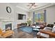 Cozy living room with fireplace, ceiling fan, and plush seating area at 21376 E Union Pl, Aurora, CO 80015