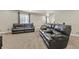 Comfortable living room with plush carpet, two leather sofas, and large window with curtains at 21376 E Union Pl, Aurora, CO 80015