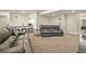 Open-concept living room with leather sofas, bar seating, and view of basement kitchen at 21376 E Union Pl, Aurora, CO 80015