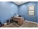Bright office featuring a large window, plush carpet, and a wooden desk with neutral decor at 21376 E Union Pl, Aurora, CO 80015
