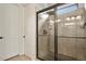 Tiled shower with glass door, showerhead, and built in shelves at 21376 E Union Pl, Aurora, CO 80015