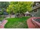 Landscaped backyard with brick pathways, lush lawn, and mature trees at 19229 E Legend Ave, Parker, CO 80134