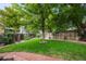 Spacious backyard with a large tree and brick pathways at 19229 E Legend Ave, Parker, CO 80134