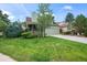 Green house with porch, attached garage, and a lush green lawn at 19229 E Legend Ave, Parker, CO 80134