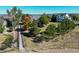 Aerial view of a home with mature trees along a walking path within a well-kept neighborhood at 3163 Soaring Eagle Ln, Castle Rock, CO 80109