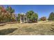 Spacious backyard featuring a multi-level deck and mature trees, perfect for outdoor living and entertaining at 3163 Soaring Eagle Ln, Castle Rock, CO 80109