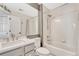 Bright bathroom featuring a shower-tub combo, large mirror, and modern fixtures at 3163 Soaring Eagle Ln, Castle Rock, CO 80109