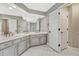 Bright bathroom with double sinks, white cabinets and tile flooring, and a glass shower at 3163 Soaring Eagle Ln, Castle Rock, CO 80109