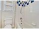 Full bathroom with a shower-tub combo and blue and white tile accents at 3163 Soaring Eagle Ln, Castle Rock, CO 80109