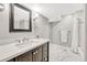 Modern bathroom with dark wood vanity, a bright white countertop and tiled shower at 3163 Soaring Eagle Ln, Castle Rock, CO 80109