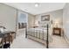 Bedroom with a large window, side tables with lamps, and a wicker chair at 3163 Soaring Eagle Ln, Castle Rock, CO 80109