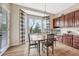 Bright breakfast nook with hardwood floors, a bay window, and modern light fixture at 3163 Soaring Eagle Ln, Castle Rock, CO 80109