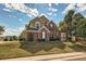 Beautiful two-story home with brick and siding, a well-manicured lawn and mature trees at 3163 Soaring Eagle Ln, Castle Rock, CO 80109