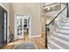 Inviting foyer with hardwood floors, staircase, and office with glass door at 3163 Soaring Eagle Ln, Castle Rock, CO 80109