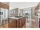 Spacious kitchen featuring stainless steel appliances, central island with cooktop, and eat-in kitchen nook at 3163 Soaring Eagle Ln, Castle Rock, CO 80109