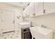 Clean laundry room featuring a washer, dryer, utility sink, and ample storage cabinets at 3163 Soaring Eagle Ln, Castle Rock, CO 80109