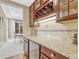 Granite counter top with wine fridge and custom cabinetry at 3163 Soaring Eagle Ln, Castle Rock, CO 80109