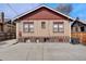 Rear exterior of home with spacious backyard and vintage window and brick details at 1418 Perry St, Denver, CO 80204
