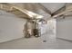 Basement utility area showing the water heater, furnace, and laundry hookups in a functional space at 1418 Perry St, Denver, CO 80204
