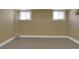Finished basement space featuring two small windows and neutral paint color at 1418 Perry St, Denver, CO 80204