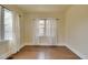 Bedroom featuring hardwood floors and white curtains at 1418 Perry St, Denver, CO 80204