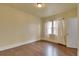 This bedroom features hardwood floors, a light fixture, and a window with bright natural light at 1418 Perry St, Denver, CO 80204