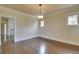 Open dining room featuring hardwood floors, a light fixture, and bright natural light at 1418 Perry St, Denver, CO 80204