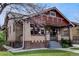 Attractive brick bungalow featuring a cozy front porch and neat landscaping, showing curb appeal at 1418 Perry St, Denver, CO 80204