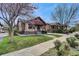 Lovely brick bungalow featuring well-kept lawns and mature trees adding to its charm at 1418 Perry St, Denver, CO 80204