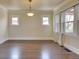 Bright living room with hardwood floors, showcasing large windows for natural light at 1418 Perry St, Denver, CO 80204