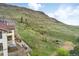 Scenic backyard view showcasing a well-maintained deck, hot tub, and serene mountain backdrop at 415 Butte Pkwy, Golden, CO 80403