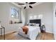 Bright bedroom featuring a ceiling fan, large windows, and natural light at 415 Butte Pkwy, Golden, CO 80403
