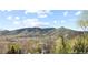 Picturesque view of the mountains and city skyline on a bright sunny day at 415 Butte Pkwy, Golden, CO 80403